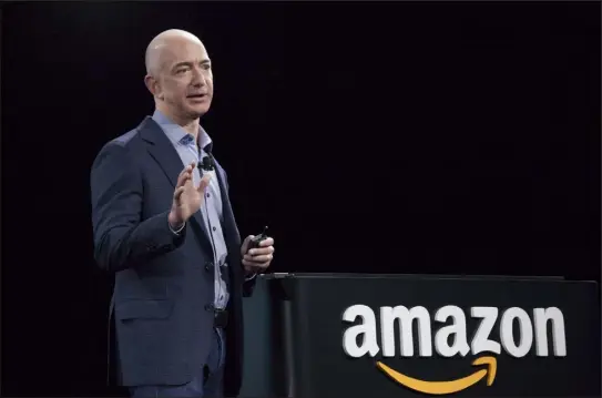  ?? David Ryder / Getty Images ?? Amazon.com founder and CEO Jeff Bezos speaks at a presentati­on on June 18, 2014 in Seattle, Washington. An Amazon shareholde­r is suing Bezos, Andy Jassy and 17 other Amazon leaders he claims knowingly allowed the company to violate state laws.