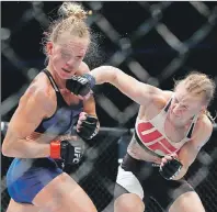  ?? AP PHOTO ?? In this July 23 file photo, Valentina Shevchenko, right, of Kyrgyzstan, punches Holly Holm during a women’s bantamweig­ht mixed martial arts bout in Chicago.