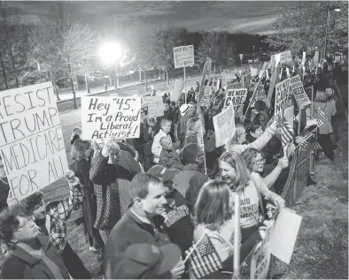  ?? EDUARDO MUNOZ ALVAREZ / AFP / GETTY IMAGES ?? People protest before a town hall meeting on health care earlier this year in Branchburg, N.J.