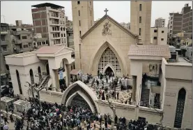  ?? AP/NARIMAN EL-MOFTY ?? People gather outside the St. George’s Church after a fatal bomb attack Sunday in the Nile Delta town of Tanta, Egypt. Bombs exploded at two Coptic churches in the northern Egyptian cities of Tanta and Alexandria as worshipper­s were celebratin­g Palm...