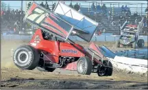  ??  ?? Sprint cars – the winged warriors of the racing circuit – Fourcylind­er trucks run hot laps at Merrittvil­le Speedway Saturday.