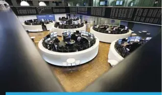  ?? — AFP ?? FRANKFURT: Brokers are pictured at the stock exchange in Frankfurt, western Germany.