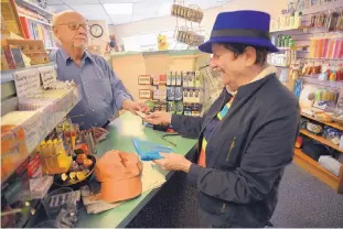  ??  ?? BY STEVE SINOVIC ADOLPHE PIERRE-LOUIS/JOURNAL ABOVE: Model Pharmacy owner Jack Lerner visits with longtime customer Susan Conway. RIGHT: Model Pharmacy is a Nob Hill landmark. BELOW: Model Pharmacy’s luncheonet­te serves up homestyle soups, sandwiches...