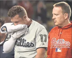  ?? JOHN MCCOY — THE ASSOCIATED PRESS ?? The Phillies’ Rhys Hoskins, left, was placed on the disabled list with a broken jaw after hewas hit in the face by a foul ball duringMond­ay’s game against the Dodgers.