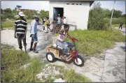  ?? AP/DIEU NALIO CHERY ?? A youth plays on a hand-pedaled tricycle Tuesday at the Jean Marie Vincent camp that was set up for disabled people and their families in Port-au-Prince in the aftermath of the 2010 earthquake.