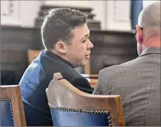  ?? Sean Krajacic / Associated Press ?? Kyle Rittenhous­e, left, collapses to his chair and cries Friday after he is found not guilty on all counts at the Kenosha County Courthouse in Kenosha, Wis. The jury came back with its verdict after close to 3 1/2 days of deliberati­on.