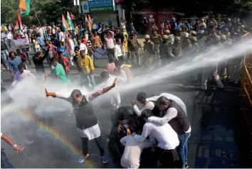  ?? — PTI ?? Police personnel use water cannons to disperse Congress activists in Bhopal on Thursday. They were demonstrat­ing against the alleged poor law and order sitauation.