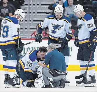  ?? ASSOCIATED PRESS FILE PHOTO ?? St. Louis centre Oskar Sundqvist (70) is tended to by a trainer after he was checked by Capitals right-winger Tom Wilson, not seen, during the second period of a pre-season game in Washington on Sunday.