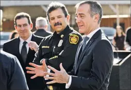  ?? Al Seib Los Angeles Times ?? LAFD CHIEF Ralph Terrazas, center, with Garcetti at a media event. Terrazas wrote to Glazier that he was “very proud of our culture of safety and training.”