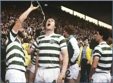  ??  ?? Roy Aitken, pictured being fed champagne by Danny McGrain, was adopted by the club