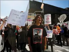  ?? AP PHOTO/DAMIAN DOVARGANES ?? High school student Sebastian Chavez (center) joins hundred of students walking out of school to rally against against gun violence Friday in downtown Los Angeles.