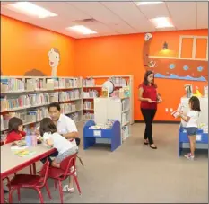  ?? WILLIAM ROLLER PHOTO ?? Library patrons utilize the Children’s Room at the Imperial Public Library during the grand opening to celebrate restoratio­n which expanded facilities and improved services Thursday in Imperial.