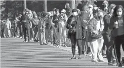  ?? GERRY BROOME/AP ?? Early voters line up to cast their ballots at the South Regional Library polling location Thursday in Durham, N.C.