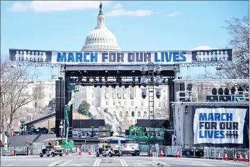  ??  ?? Constructi­on workers setup the ‘March For Our Lives’ stage ahead of the anti-gun rally in Washington, DC. — AFP photo