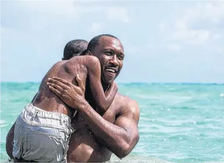  ?? David Bornfriend A24 ?? MAHERSHALA ALI plays Juan in a touching scene with Alex Hibbert in which he teaches the boy how to swim.