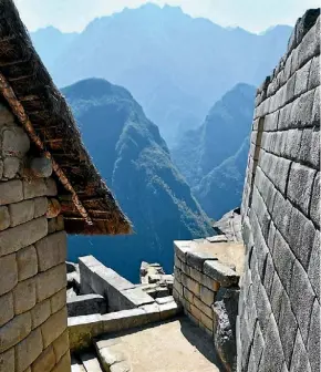  ??  ?? Stone walls look over the surroundin­g mountains at Machu Picchu.