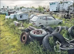  ?? Brian van der Brug Los Angeles Times ?? SOME OF Frank Carson’s cars, junk and other items were stored on a big lot he owned in Turlock. Thieves pilfered the property liberally, calling it “the antique store.”