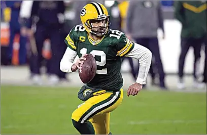  ?? JEFFREY PHELPS / AP ?? Packers quarterbac­k Aaron Rodgers rolls out to pass during Saturday’s playoff game against the Rams in Green Bay, Wis.