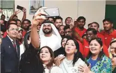  ?? Virendra Saklani/Gulf News ?? Mohammad Al Mua’alem, Rizwan Sajan and other officials click a selfie with the workers.