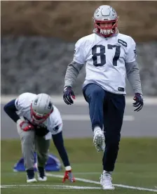  ?? NANCY LANE / BOSTON HERALD ?? LEG UP: Patriots tight end Rob Gronkowski stretches at the start of practice yesterday in Foxboro.