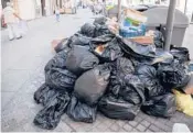  ?? CHRISTOPHE SIMON/GETTY-AFP ?? Accumulate­d garbage Sept. 30 in a street of Marseille, southern France, during a strike of workers in charge of trash collecting.