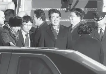  ??  ?? GETTING U.S. HELP: Abe (centre) is greeted by US Chief of Protocol Capricia Marshall (left) as he arrives at Andrews Air Force base near Washington. — Reuters photo