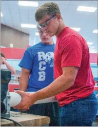  ?? WILLIAM HARVEY/TRILAKES EDITION ?? Josh Burnham, left, watches his brother, Jack Burnham, sand a piece of plastic pipe for a T-shirt cannon they are making in a preenginee­ring class at Arkadelphi­a High School. A two-day industry fair highlighti­ng jobs in the pre-engineerin­g and...