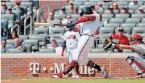  ?? KEVIN C. COX
GETTY IMAGES ?? Ronald Acuna Jr. launches his 40th homer of the season against the Philadelph­ia Phillies at SunTrust Park in Atlanta on Thursday.