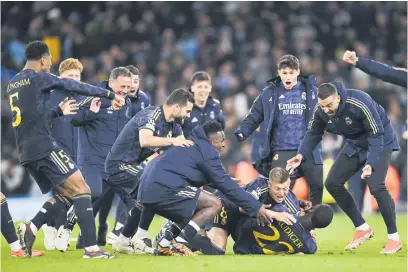  ?? Picture: Getty Images ?? SHEER ELATION. Real Madrid’s Antonio Rudiger is mobbed by team-mates after scoring the winning penalty in the shoot-out in the Champions League quarterfin­al second leg clash against Manchester City at the Etihad on Wednesday night.