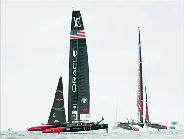  ?? GREGORY BULL/AP PHOTO ?? Oracle Team USA, left, races Emirates Team New Zealand during the sixth race of America’s Cup on Saturday in Hamilton, Bermuda. Team USA won the first for its first victory of the championsh­ip competitio­n.