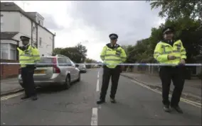  ?? JONATHAN BRADY — PA VIA AP ?? Police officers secure a road in Sunbury-on-Thames, southwest London, as part of the investigat­ion into Friday’s Parsons Green bombing, Saturday.