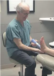  ??  ?? David Greenberg, a podiatrist and Doctor of Podiatric Medicine (D.P.M.), uses Shock Wave Therapy to treat a patient at Feetdocs’ Broadview Avenue clinic.
