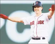  ?? Adam Glanzman / Getty Images ?? Red Sox infieler Brock Holt reacts after hitting a two- run double in the fifth inning against the Mets at Fenway Park on Saturday in Boston.