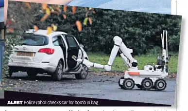  ??  ?? ALERT
Police robot checks car for bomb in bag