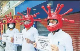  ?? ANI ?? Red Cross supporters wearing special helmets spread Covid-19 awareness during a campaign in Jammu on Wednesday.