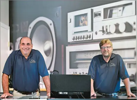  ?? TIM MARTIN/THE DAY ?? John Miceli, left, owner of Castle Hill Audio Video in Mystic, with David Allen, general manager, this past week. The business recently moved to Jackson Avenue.