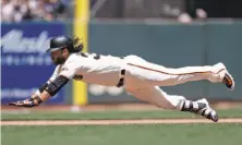  ?? Marcio Jose Sanchez / Associated Press ?? Brandon Crawford slides into third with an RBI triple in the fourth inning, giving the Giants the lead and ending an 0-for-18 slump that straddled his three-day paternity leave.