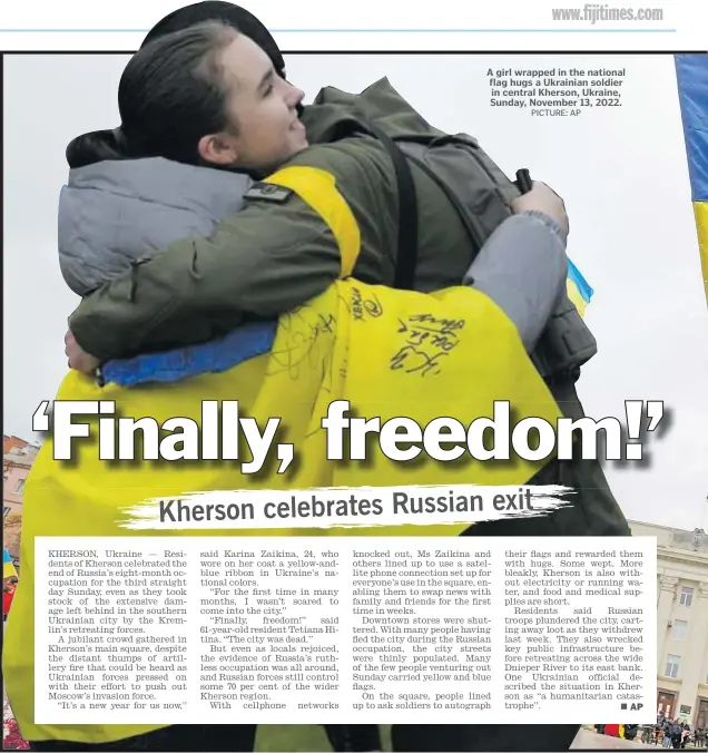  ?? ?? A girl wrapped in the national flag hugs a Ukrainian soldier in central Kherson, Ukraine, Sunday, November 13, 2022.