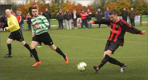  ??  ?? Nathan Brennan of Gorey Rangers gets a pass away as Ross Reardon of Gorey Celtic closes in.