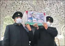  ?? REUTERS ?? The coffin of the scientist Mohsen Fakhrizade­h killed on Friday is carried at the shrine of Imam Reza in Mashhad, on Sunday.