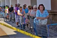  ?? CHANG W. LEE/THE NEW YORK TIMES ?? Shoppers line up outside a Walmart in Lynn Haven, Fla., on Oct. 14, 2018, after Hurricane Michael.