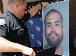  ?? IRFAN KHAN/LOS ANGELES TIMES ?? Cpl. Charles Starnes displays a photo of the suspect in a killing spree that left four dead, prior to a news conference at police headquarte­rs in Garden Grove on Thursday.