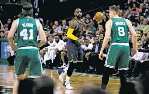  ?? CHARLES KRUPA/ASSOCIATED PRESS FILE PHOTO ?? Cavaliers forward LeBron James, center, eyes Celtics players Kelly Olynyk, left, and Jonas Jerebko in April during a game in Boston. James faces the Celtics in the playoffs for the first time since 2012, when James led the Miami Heat past Boston in the...