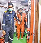  ?? — PTI ?? Rescued crew members of the barge P305, being brought at an Indian Naval Ship off the Mumbai coast on Thursday.