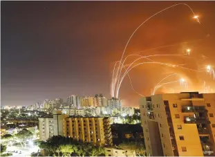  ?? (Ammar Awad/Reuters) ?? THE IRON Dome anti-missile system intercepts a rocket launched from the Gaza Strip toward Israel, as seen from Ashkelon last month.