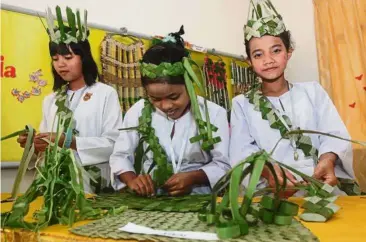  ??  ?? In touch with nature: The orang asli students of SMK Bandar Behrang 2020 weaving handicraft made from leaves at their school exhibition booth.