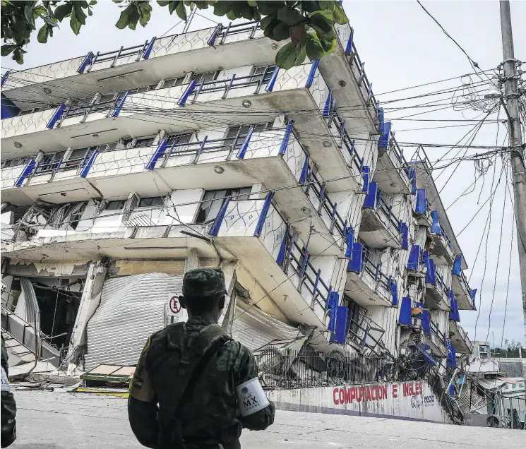  ?? VICTORIA RAZO / AFP / GETTY IMAGES ?? Soldiers guard what’s left of a hotel in Oaxaca State, Mexico, on Friday after an earthquake struck the Pacific coast of the country, killing at least 60 people and destroying homes.