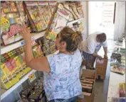  ?? OSUNA PHOTO ?? Volunteers stock a variety of fireworks inside their stand in the parking lot of Vons in Brawley prior to customers arriving on Wednesday afternoon. VINCENT