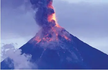  ??  ?? The Mayon volcano spews lava as it continues to erupt, as seen from Legazpi City in Albay province, south of Manila. — AFP photo