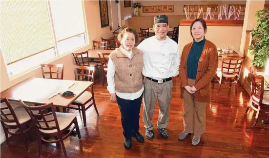  ?? Ned Gerard/Hearst Connecticu­t Media ?? From left, wife and husband co-owners Mei Lin Chang Wu and Shan Yu Chang with their granddaugh­ter, Fiona Liu, in the dining room at Formosa Asian Fusion Restaurant, in North Haven on Dec. 28, 2022.